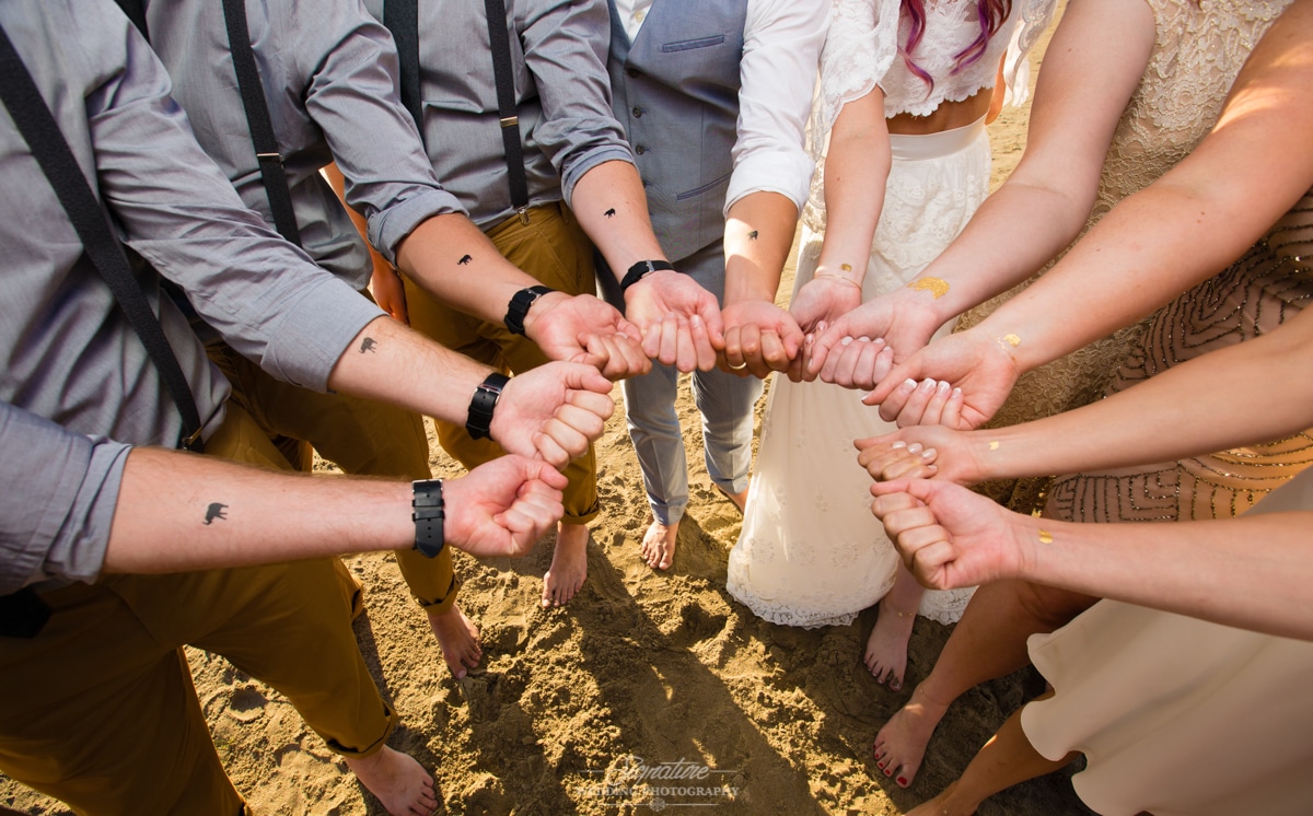 wedding party holding sand