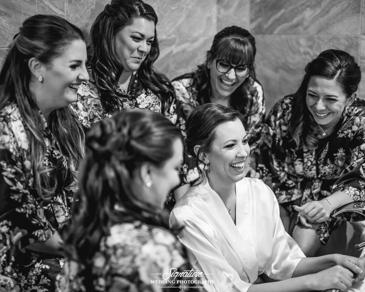 Bride and bridesmaids in robes in tub black and white