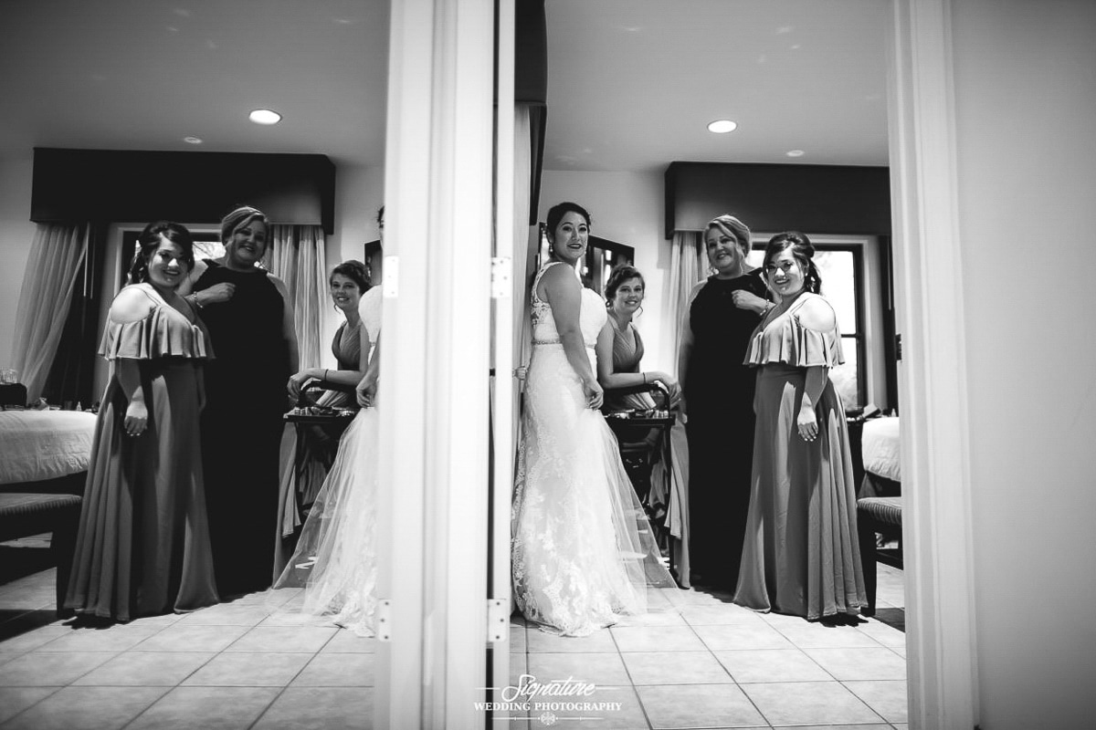 Bride with bridesmaids mirrored picture black and white