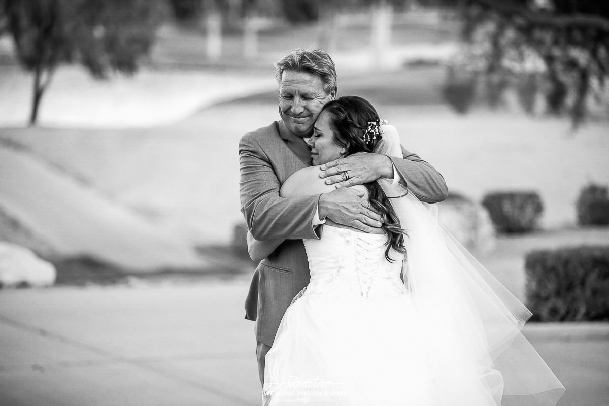 Bride hugging father black and white