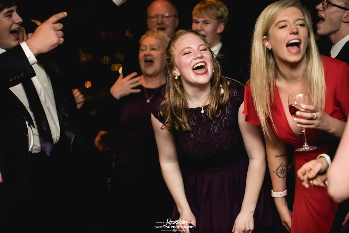 Wedding guests smiling at reception