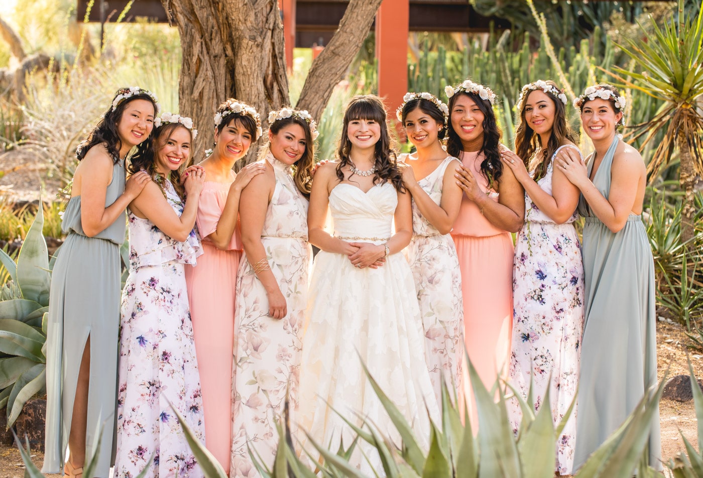 Bride and bridesmaids smiling outside