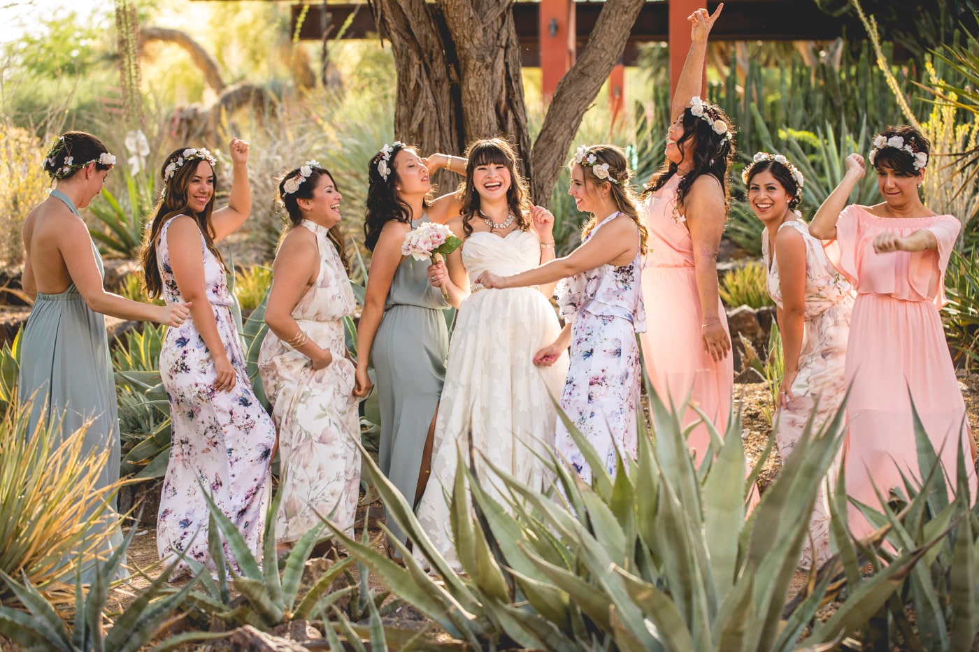 Bride and bridesmaids in fun pose outside