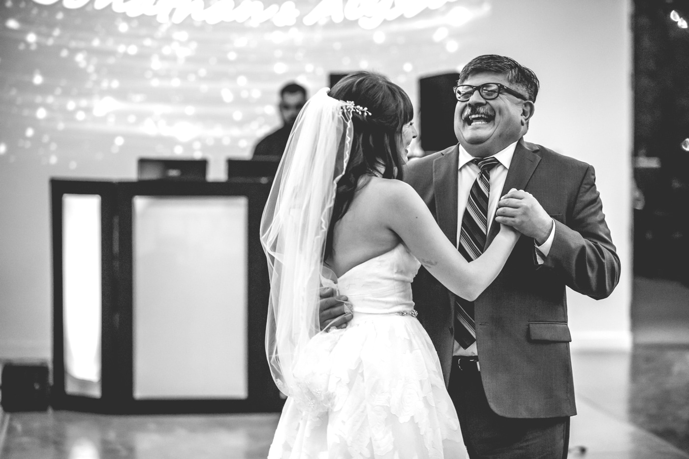 Father and bride dancing black and white