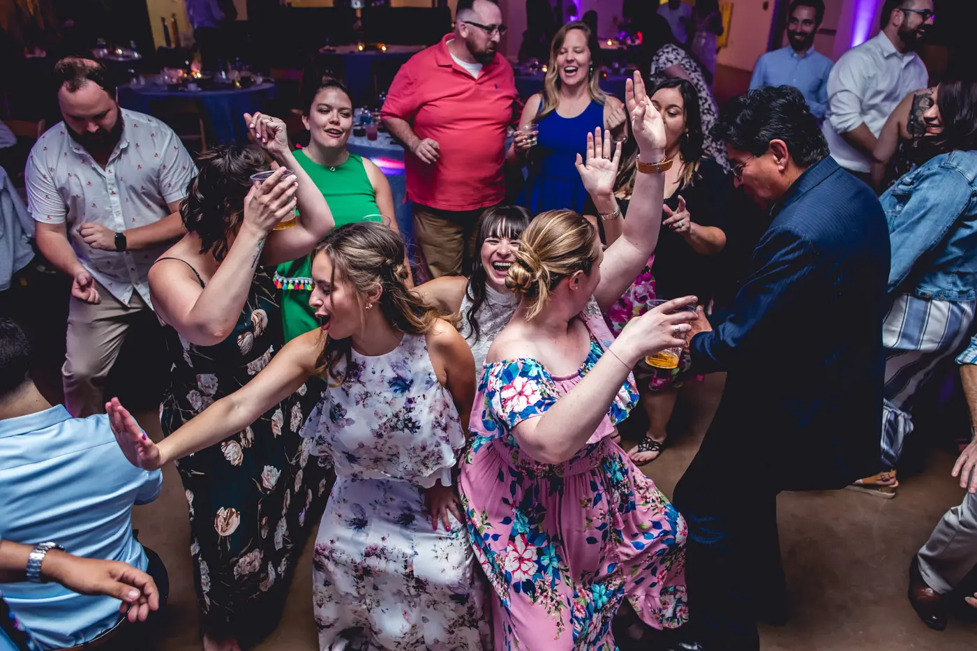 Wedding guests dancing together candid