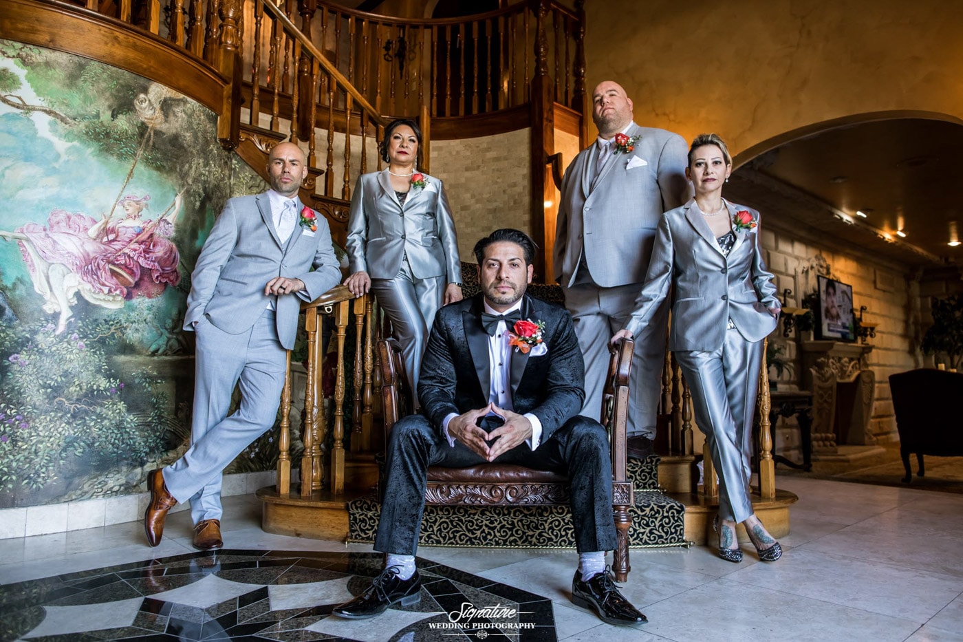 Groom with grooms party posed on stairs inside