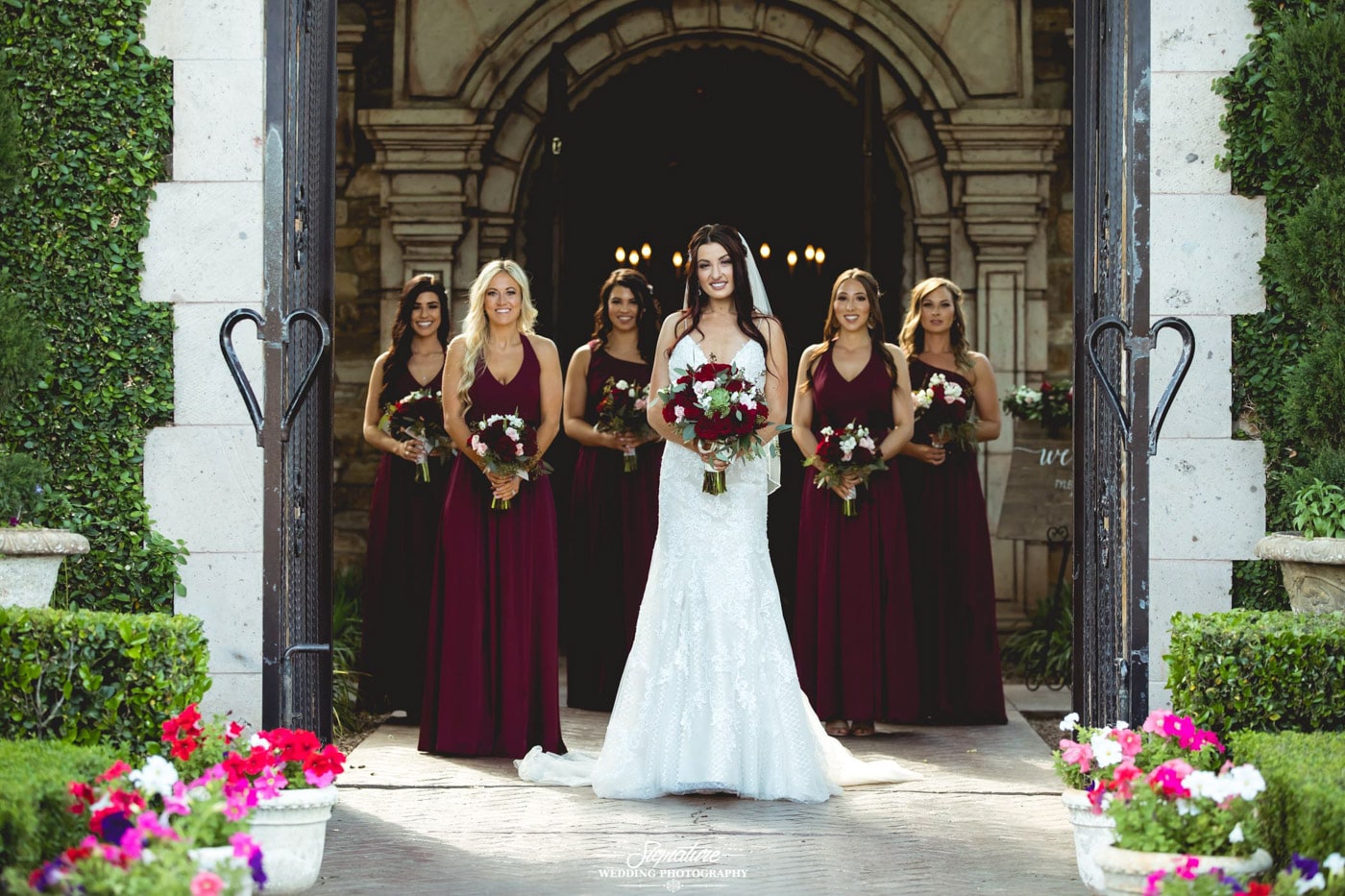 Bride and bridesmaids in open gateway outside