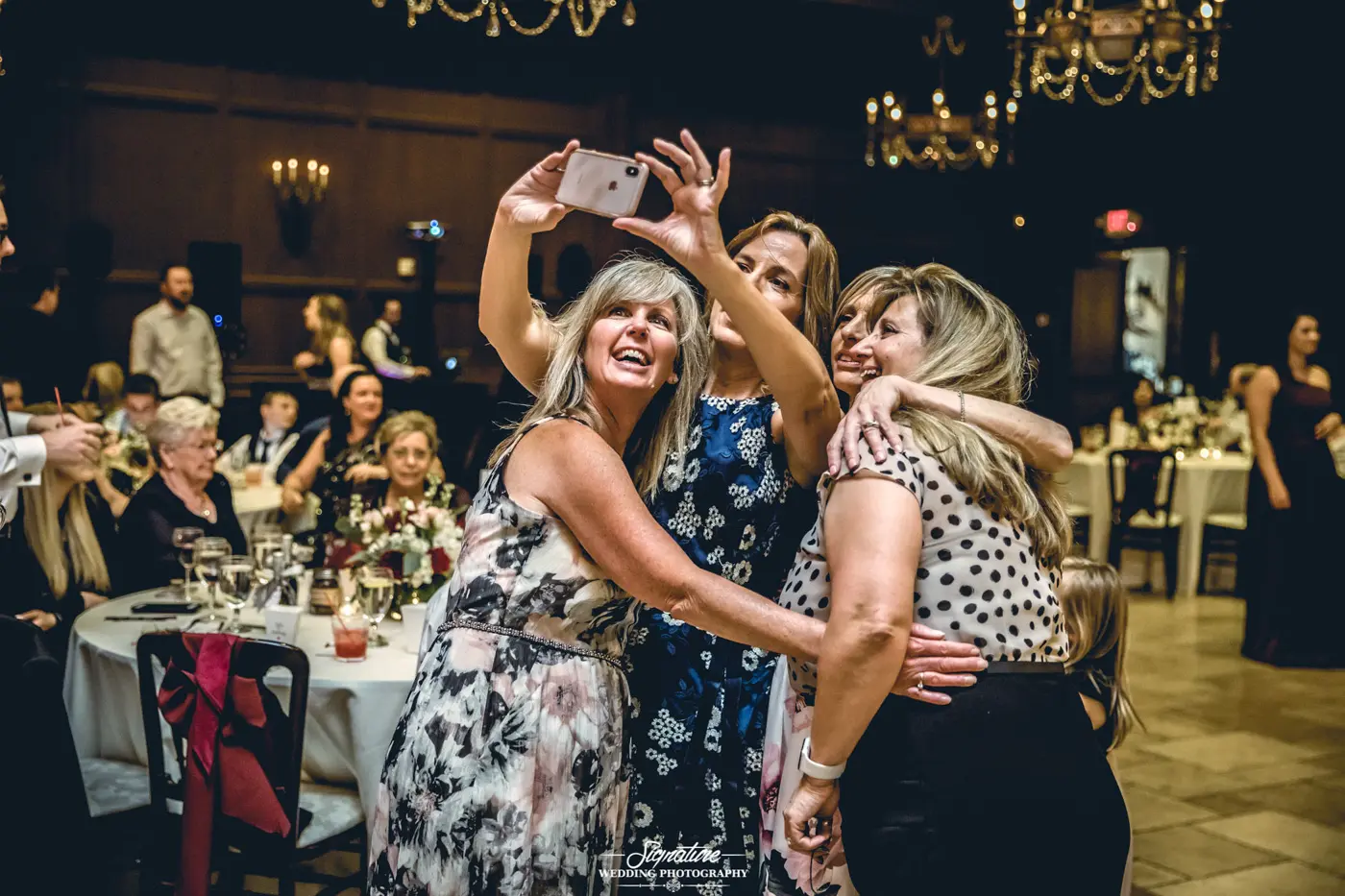 Wedding guests taking photo together at reception