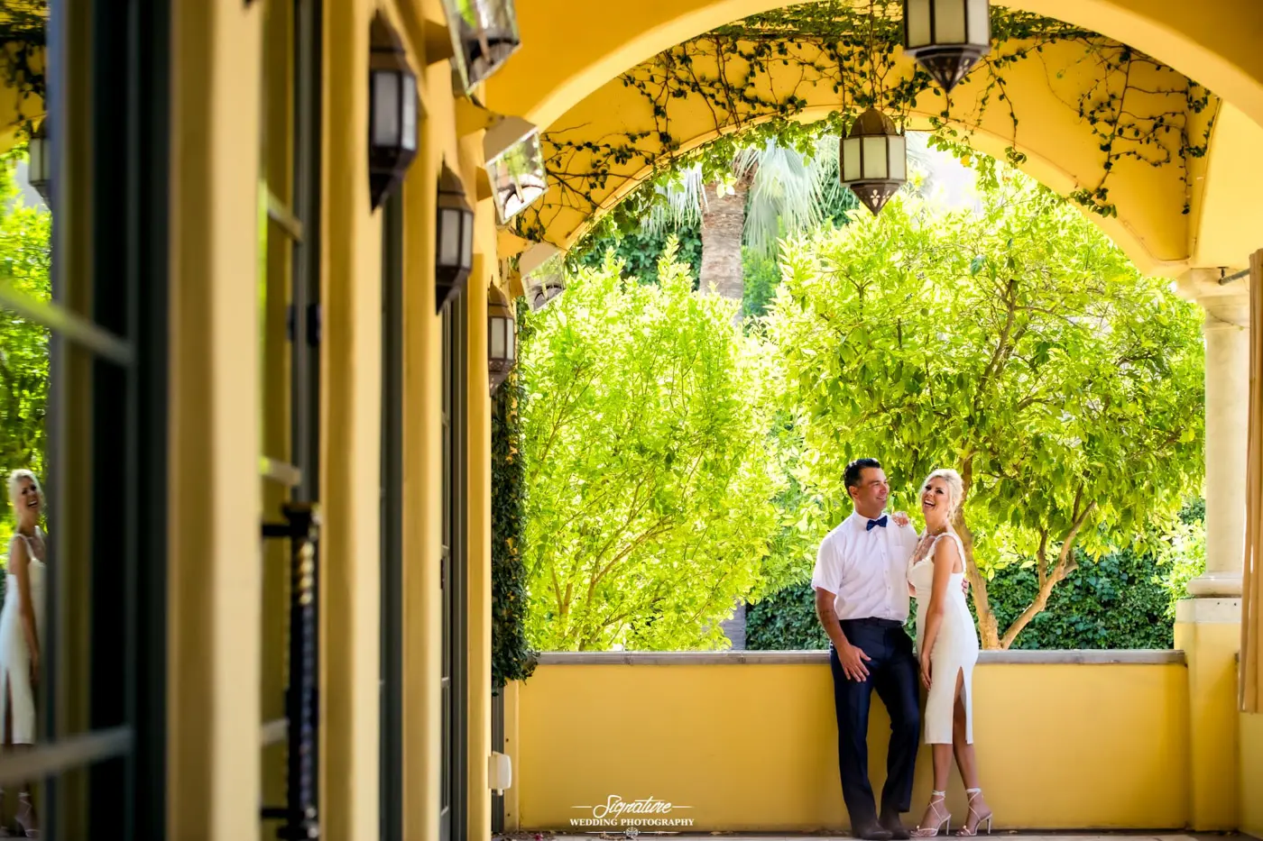 Bride and groom outside in front of tree