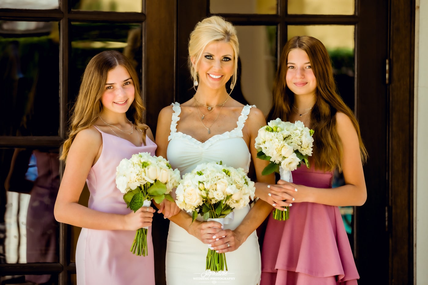 Bride with daughters holding bouquets
