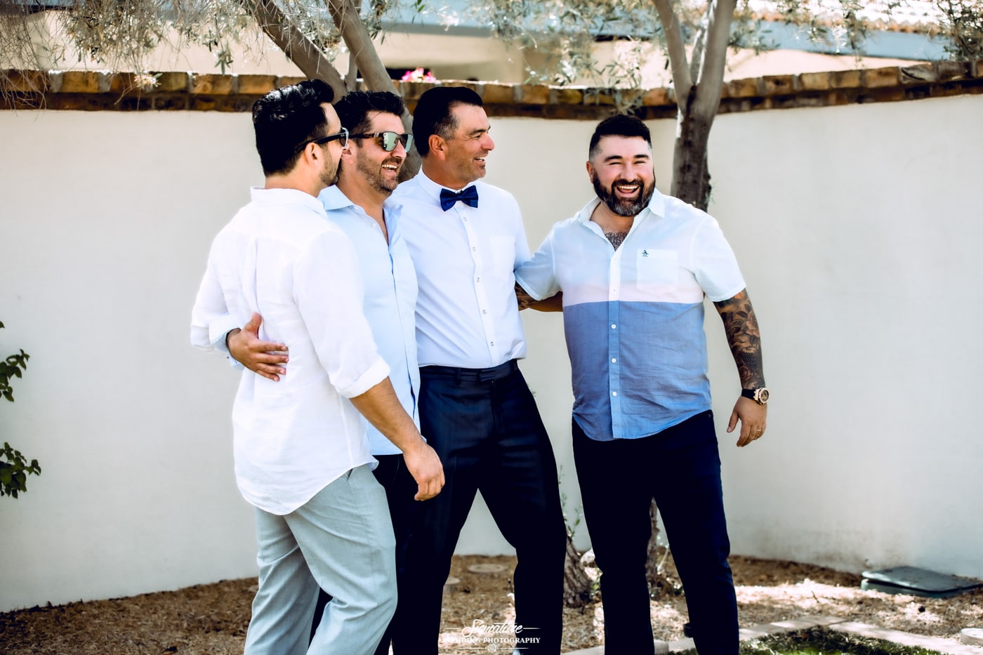 Groom and groomsmen smiling at each other