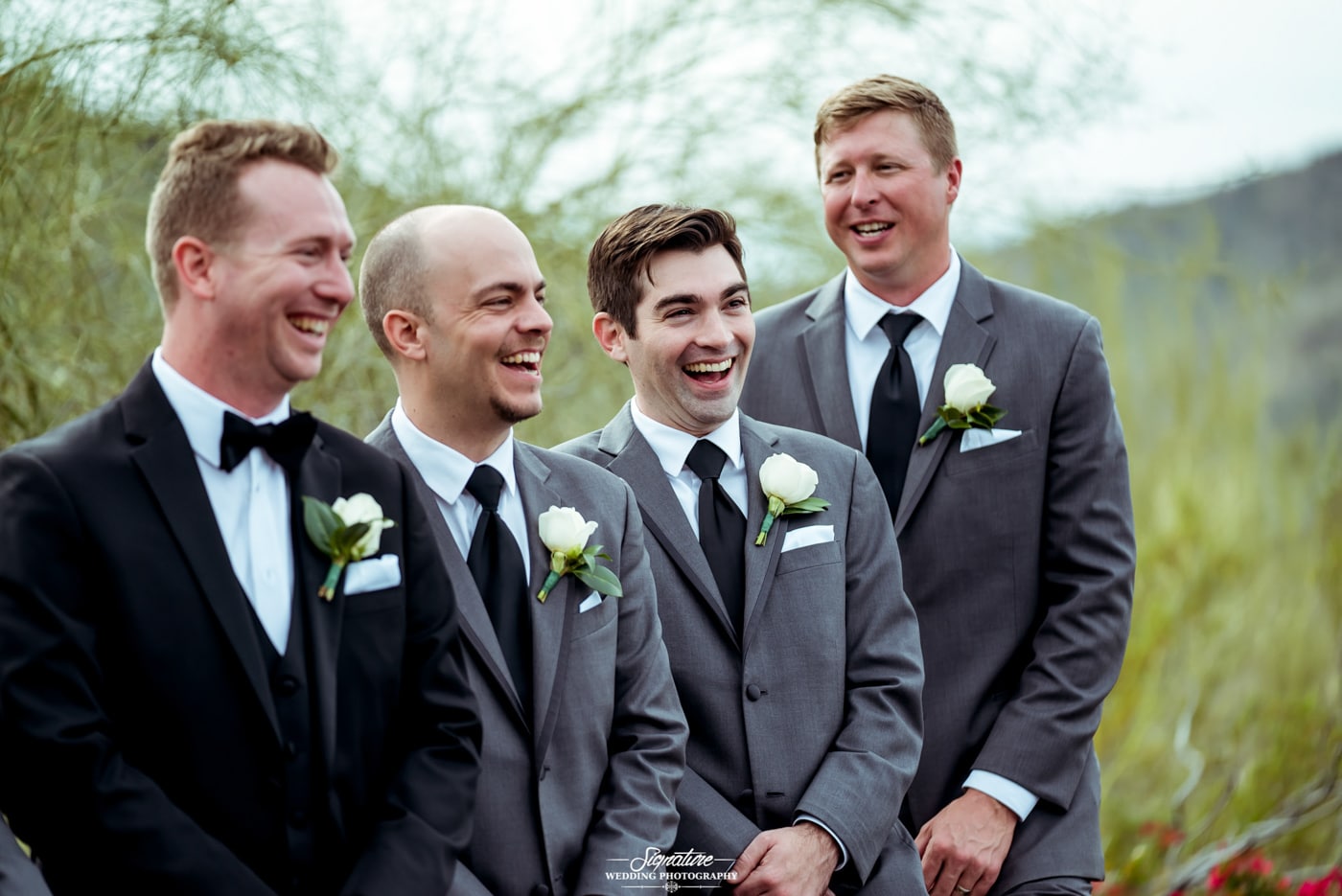 Groom and groomsmen laughing candid