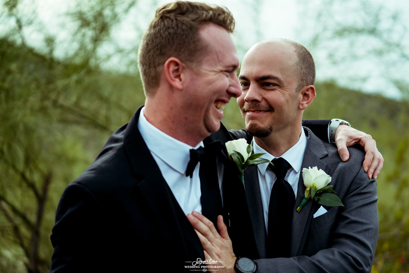 Groom and best man smiling candid