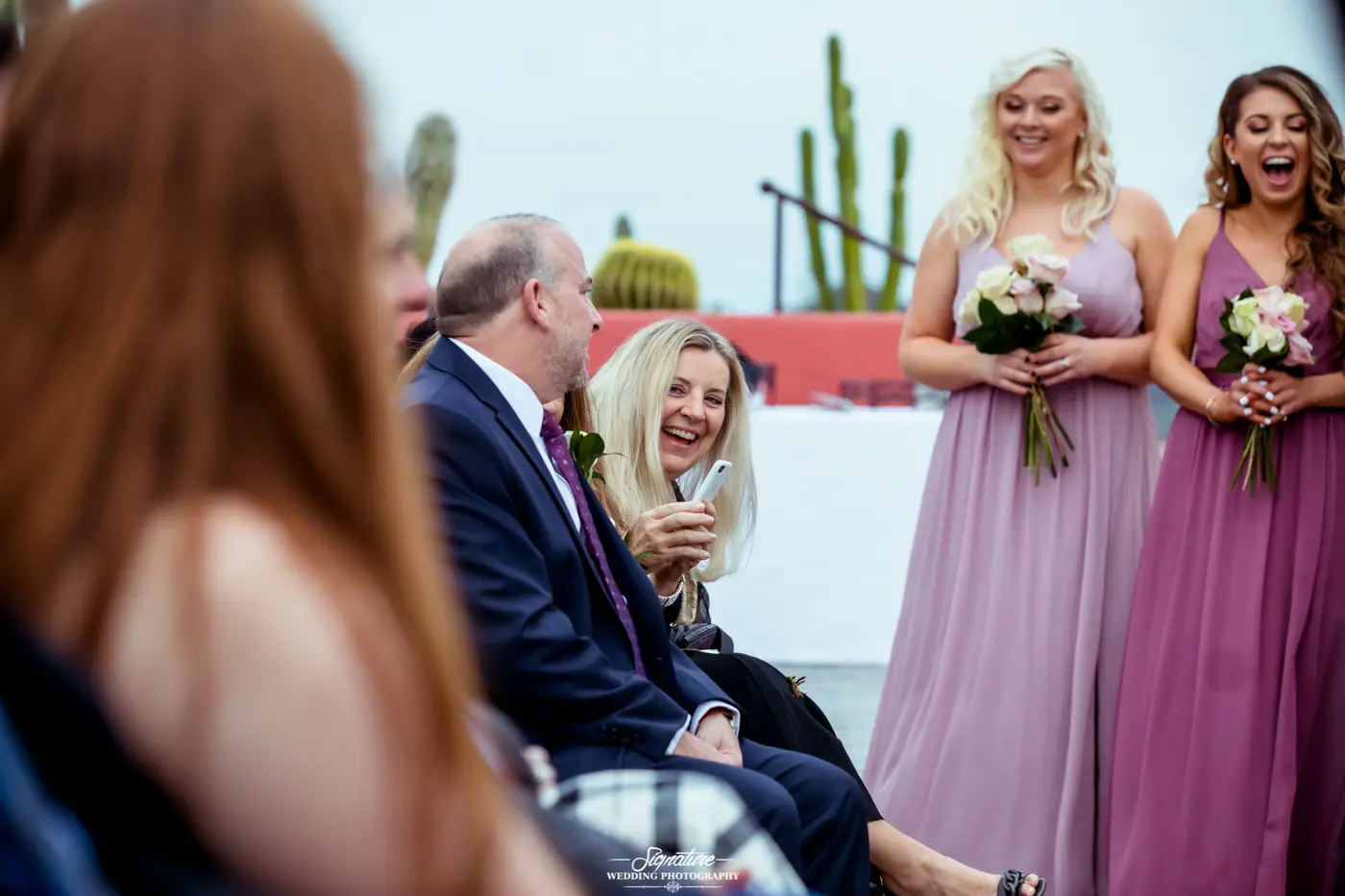 Wedding guests smiling at ceremony candid
