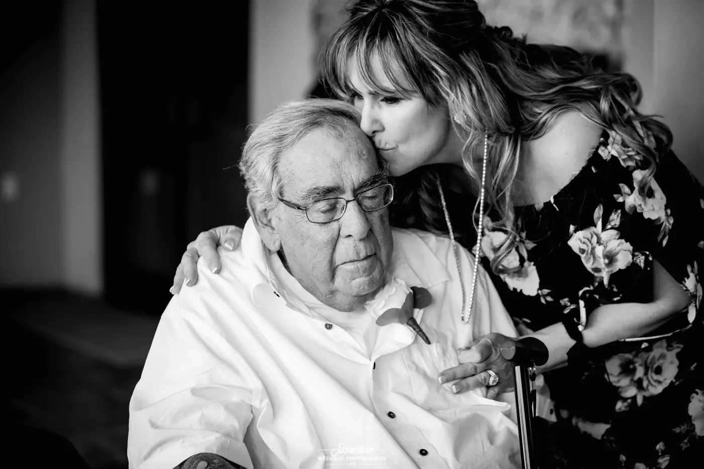 Woman kissing patriarch on forehead