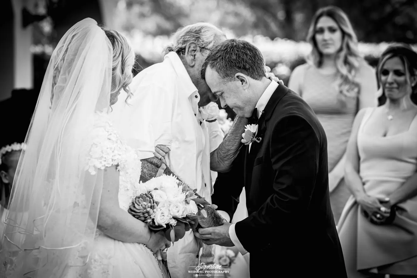 Patriarch talking to groom black and white