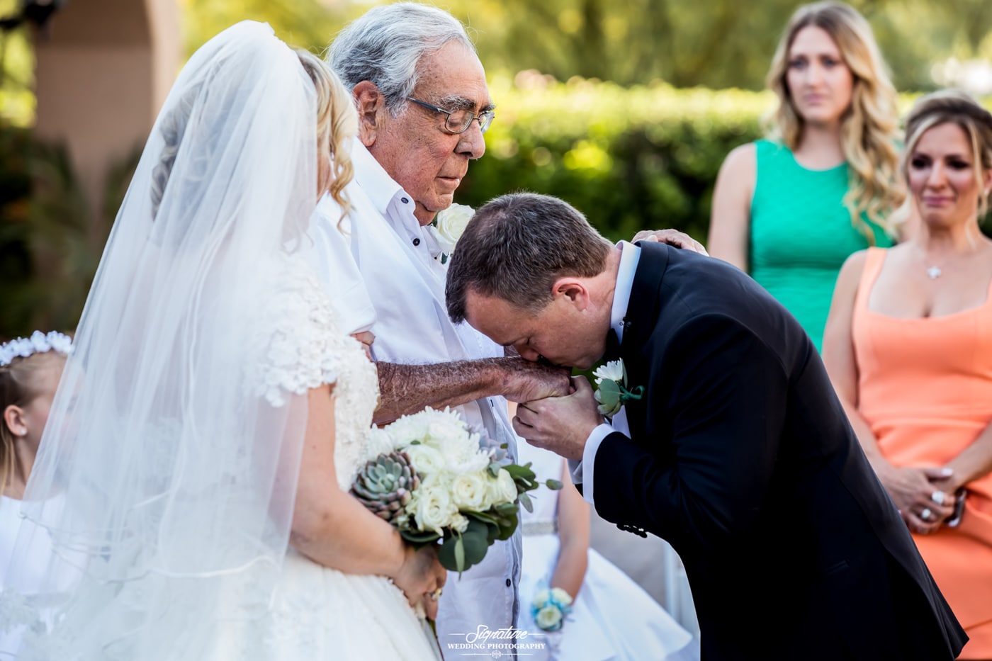 Groom kissing patriarch's hand