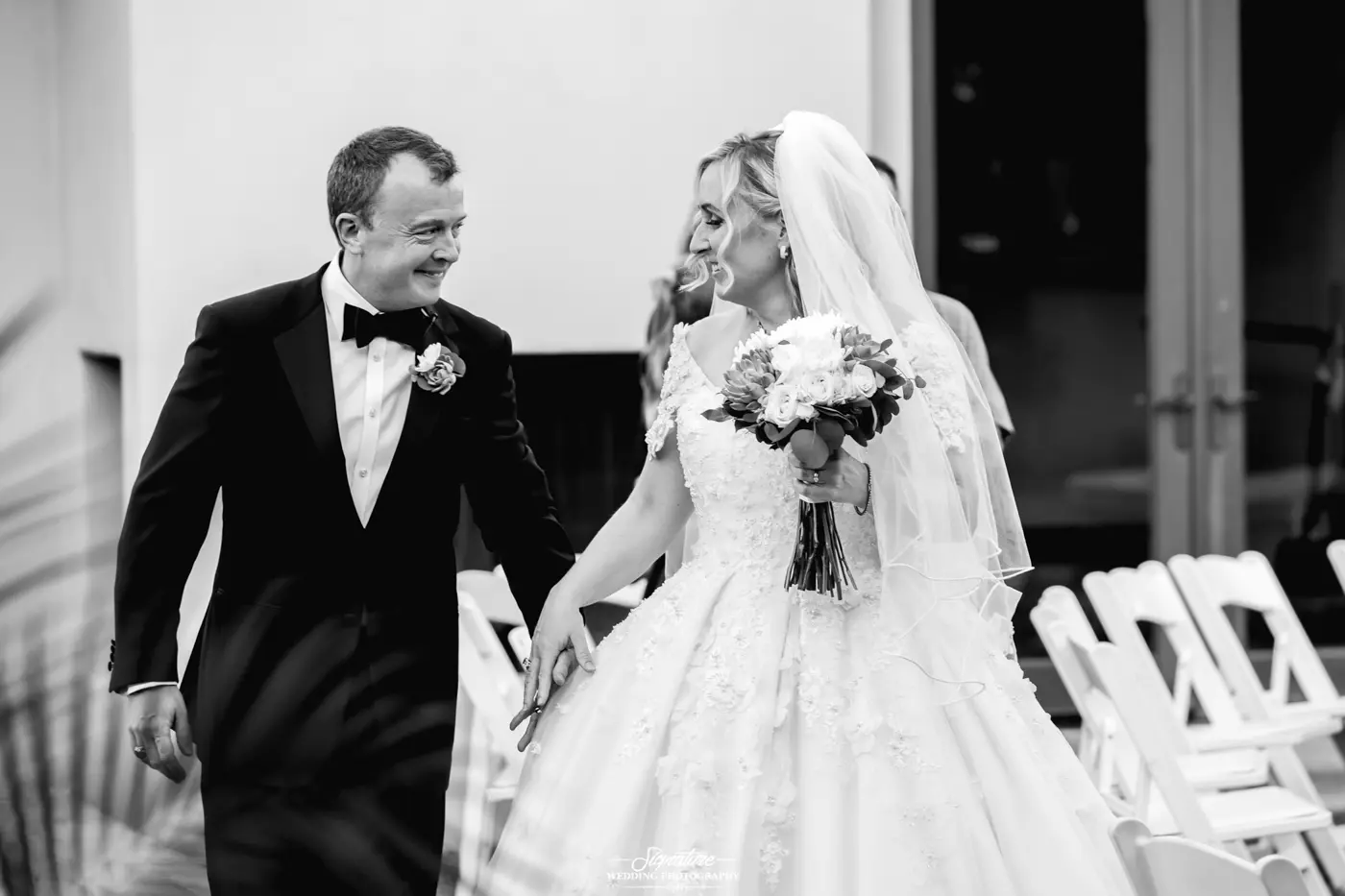Bride and groom holding hands black and white
