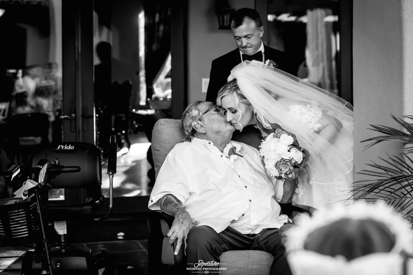 Patriarch kissing bride on cheek