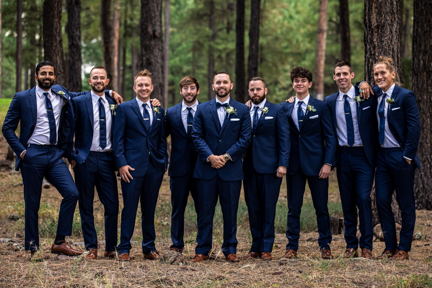 Groom and groomsmen in forest