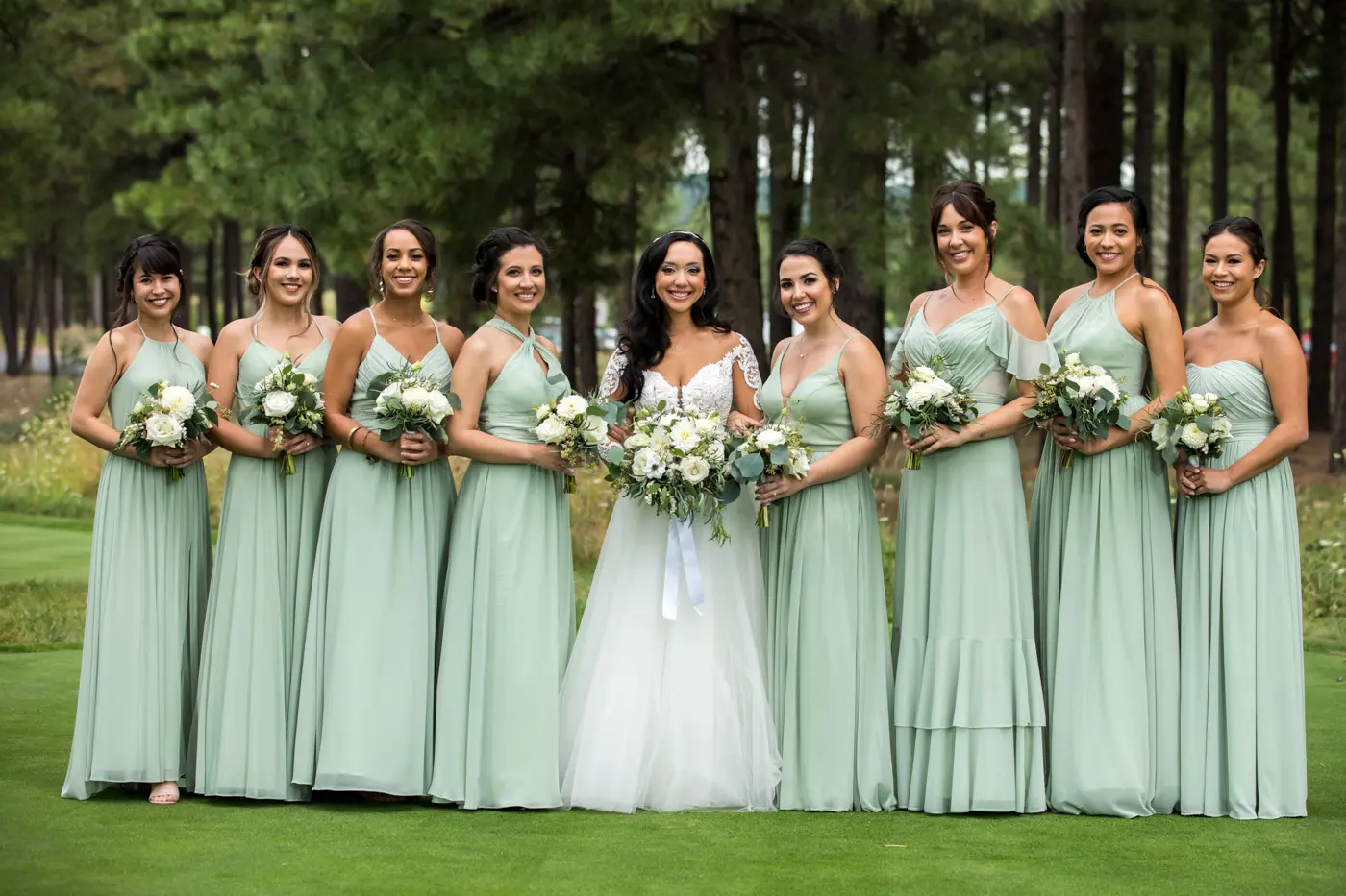 Bride and bridesmaids smiling at camera