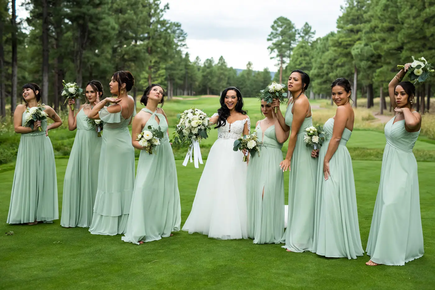Bride and bridesmaids fun pose outside side shot