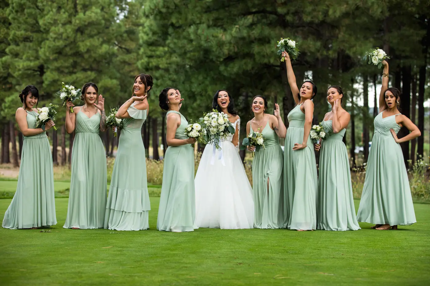 Bride and bridesmaids fun pose outside
