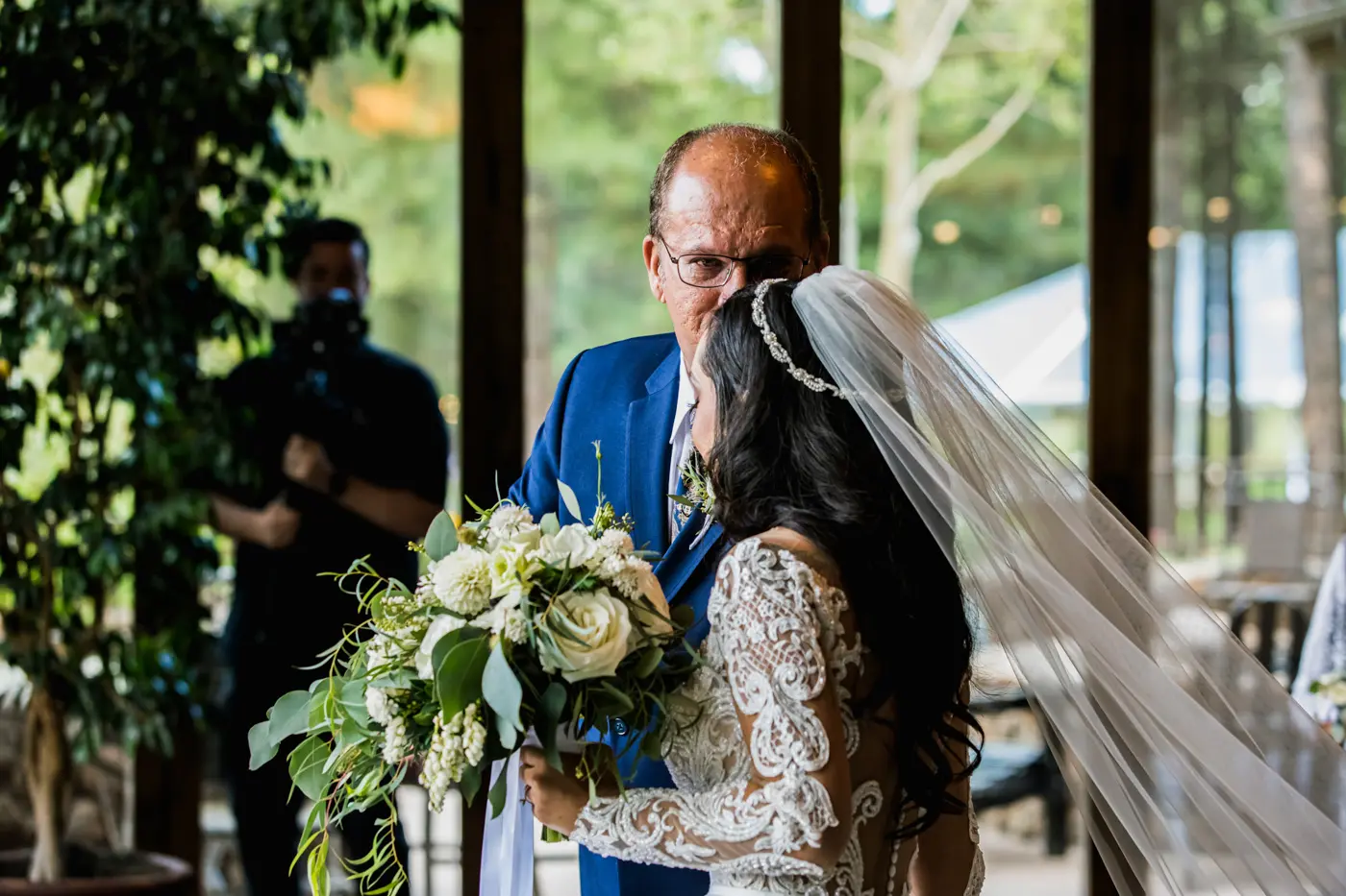 Father kissing bride on forehead