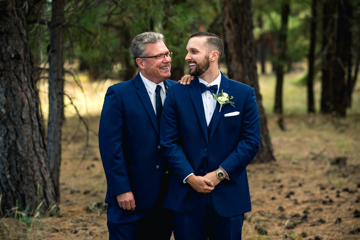 Groom with father smiling at each other