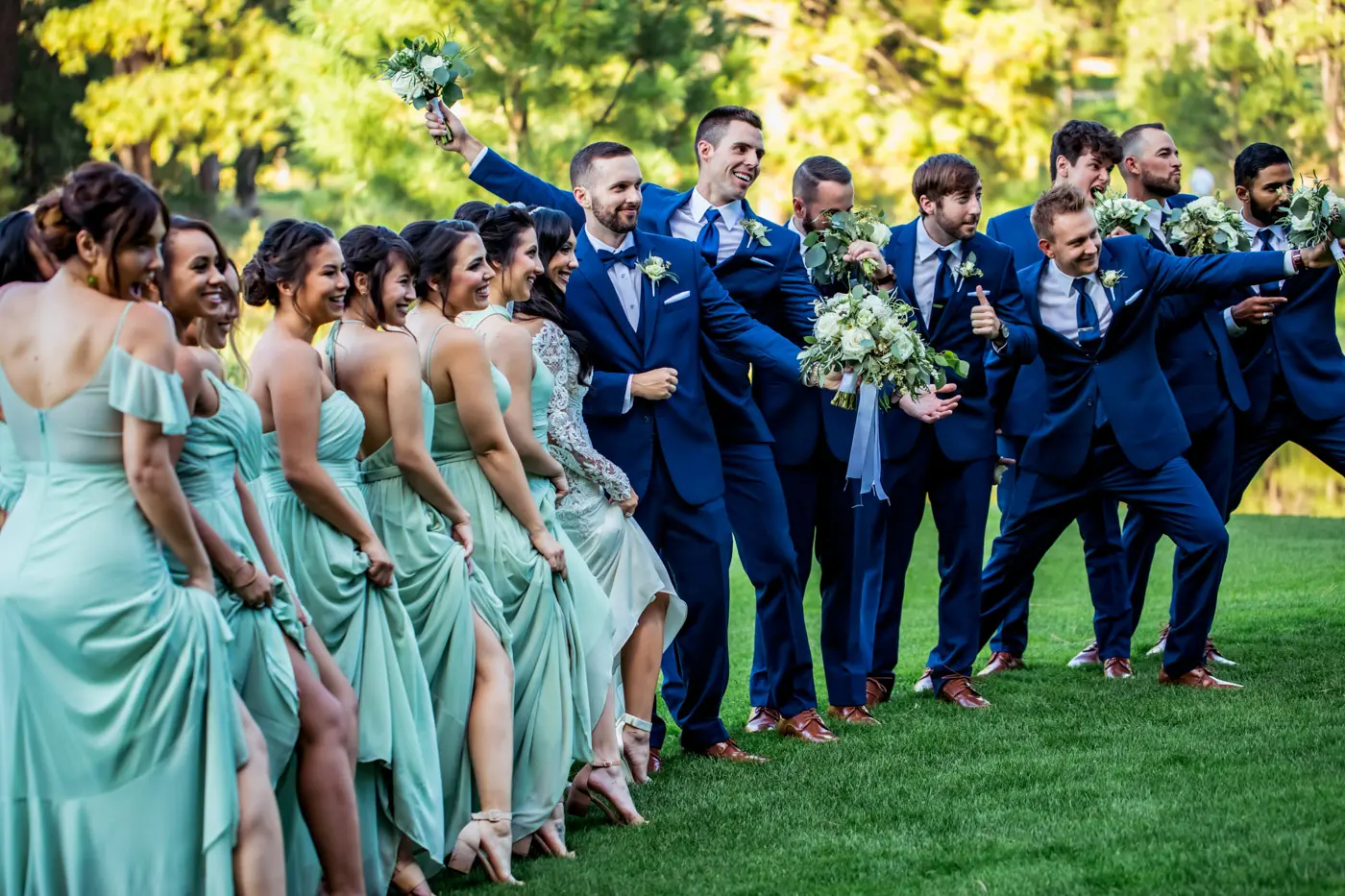 Bride and groom with wedding party fun pose