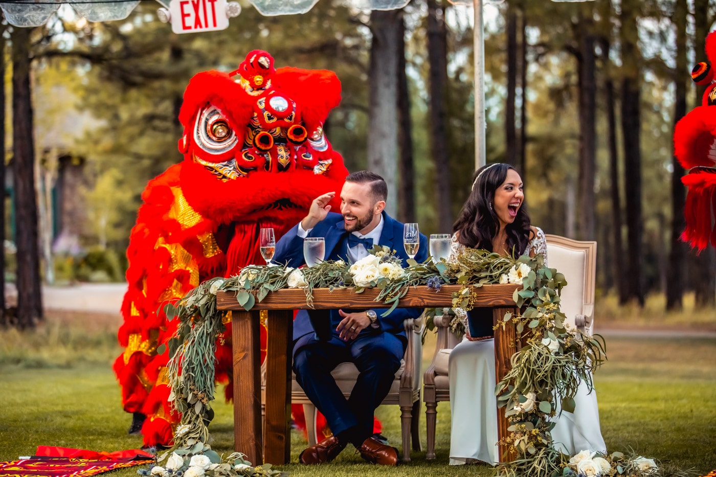 Bride and groom at sweetheart table with Chinese dragon
