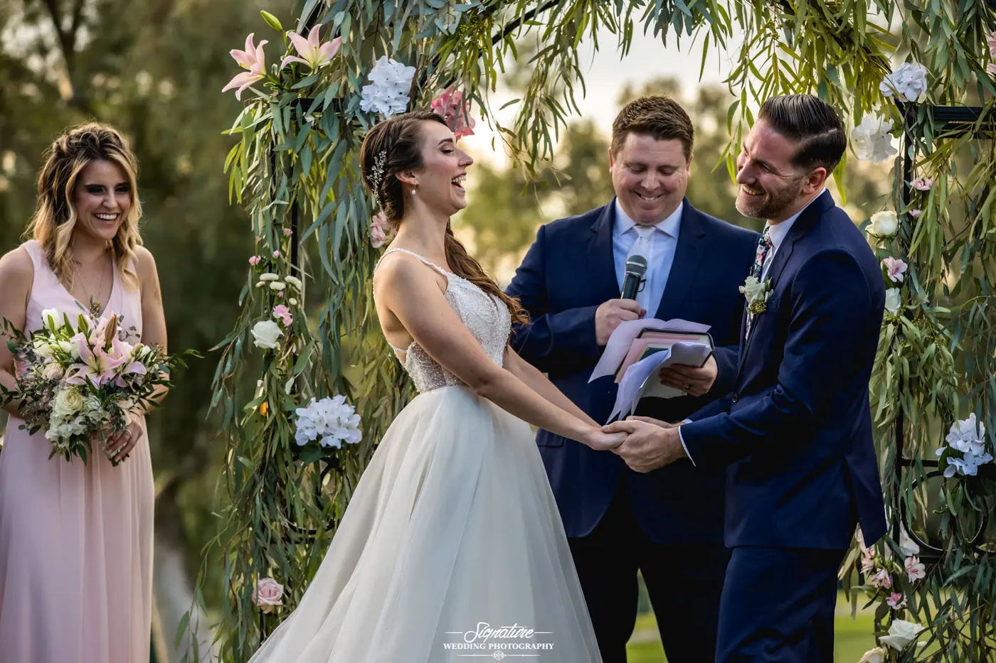 Bride and groom holding hands during ceremony