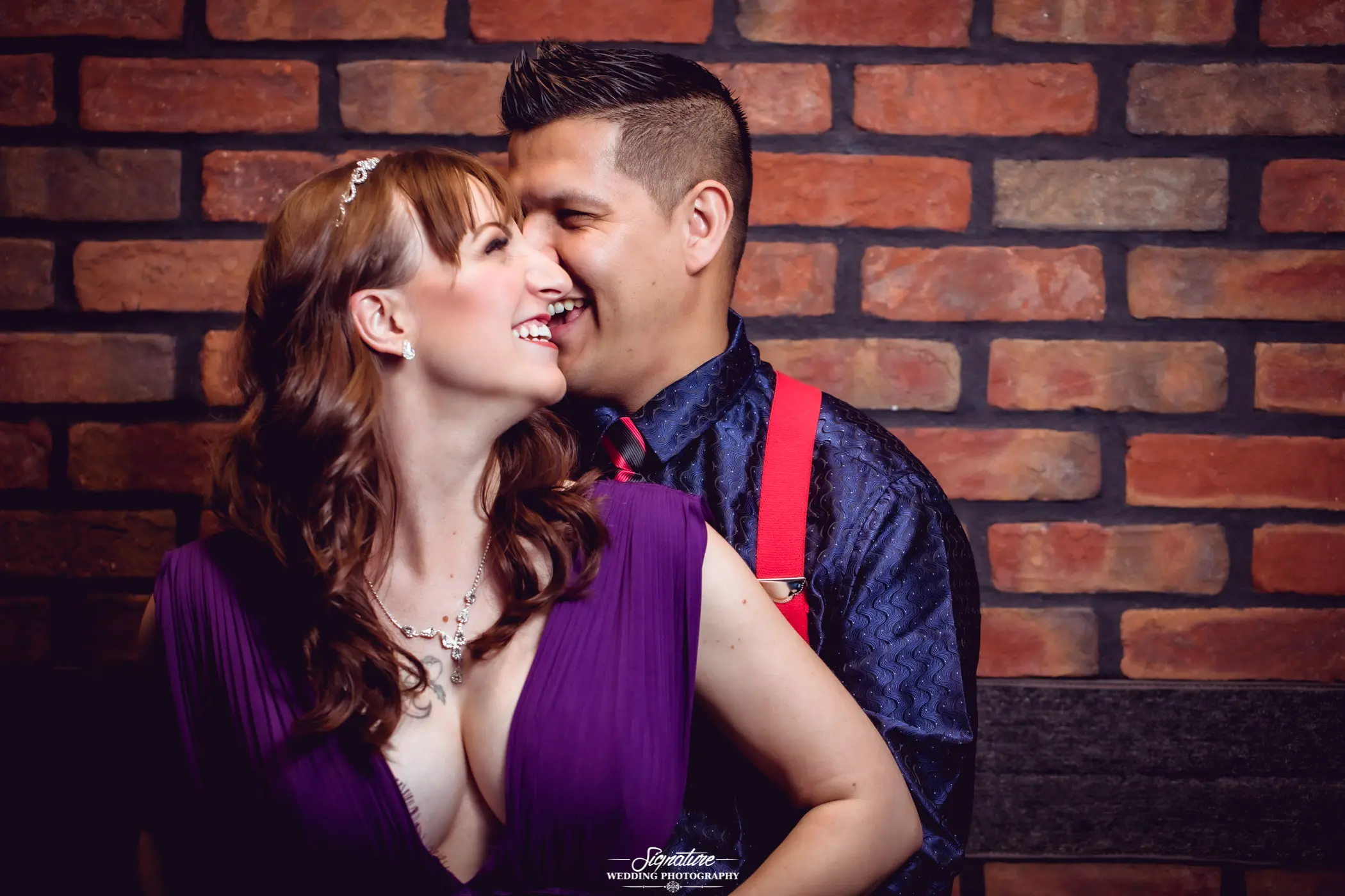 Man standing behind woman laughing together