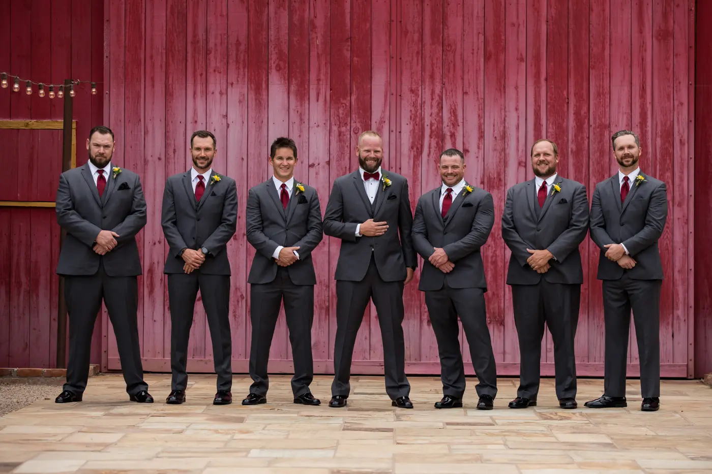 Groom and groomsmen smiling at camera