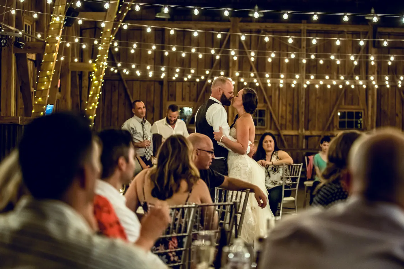 Bride and groom dancing together under lights