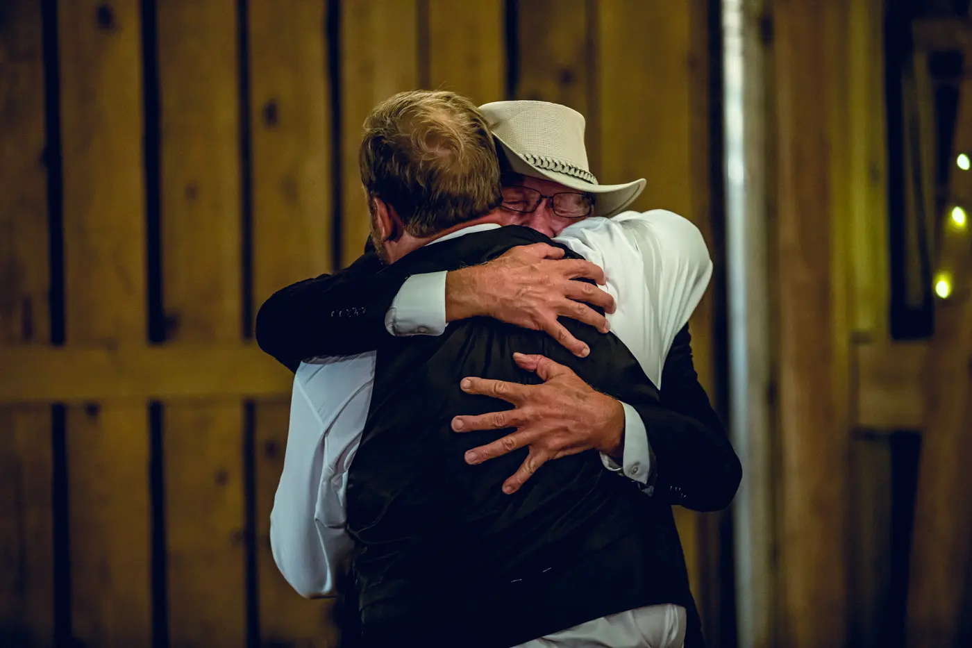 Groom and patriarch hugging