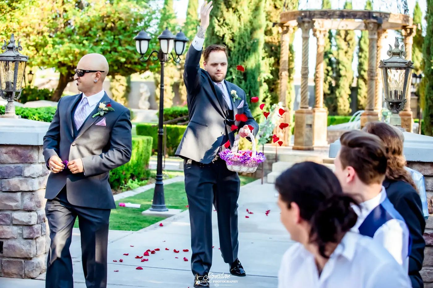 Ring security and flower man tossing petals down aisle