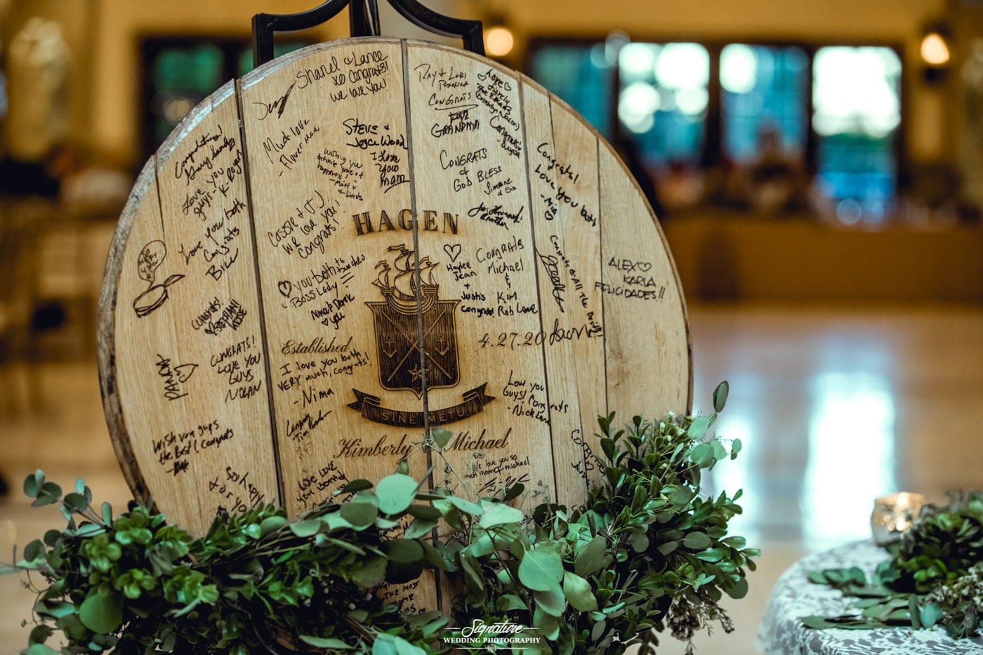 Guest signatures on wooden sign