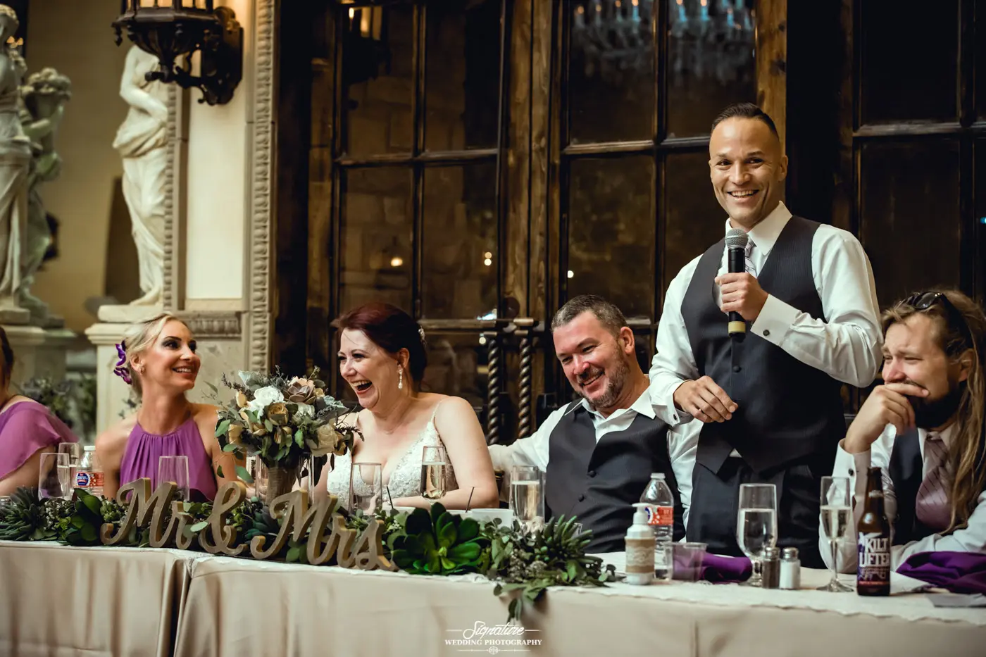 Best man giving speech wedding party laughing