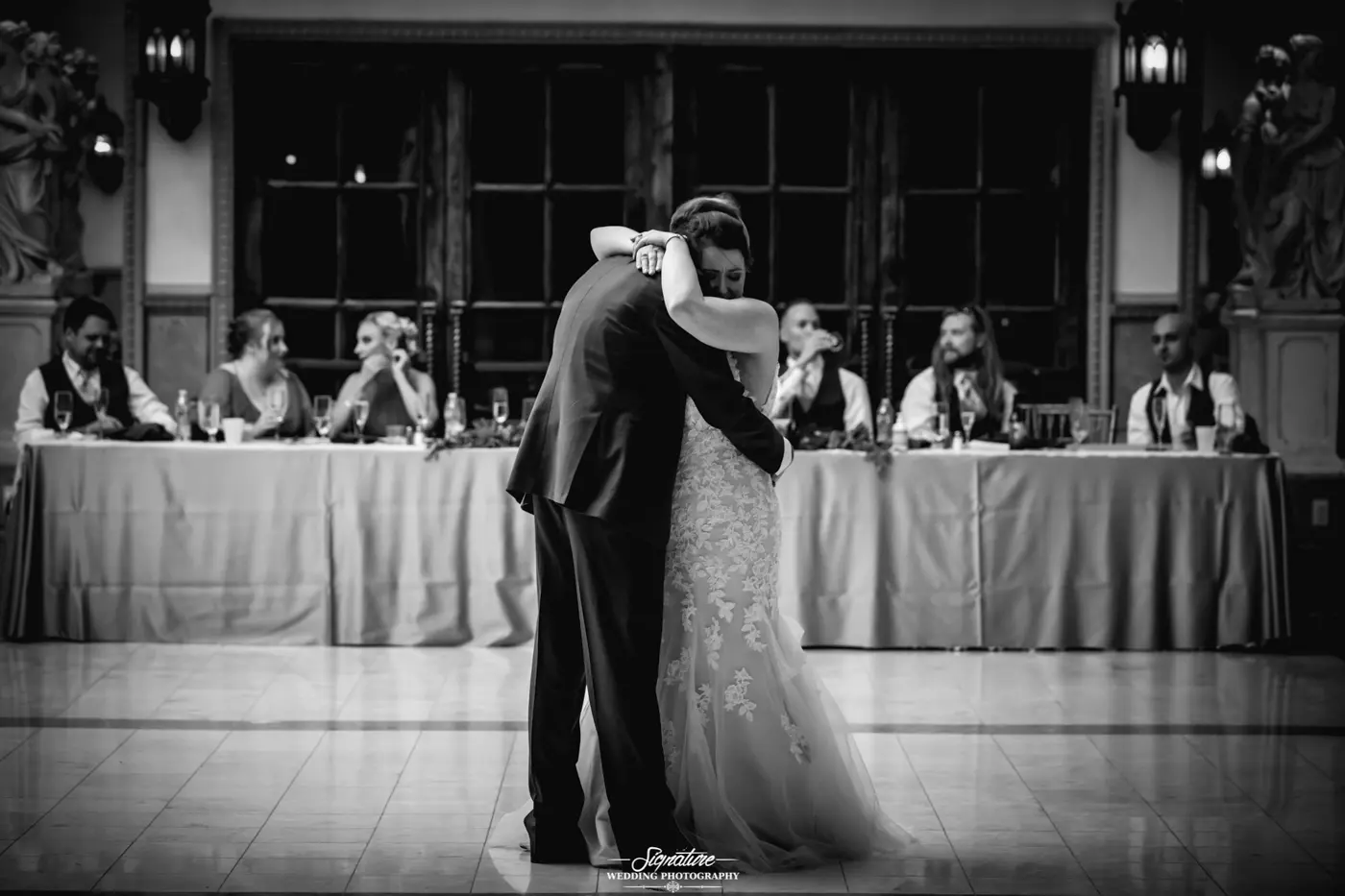 Bride and father dancing together black and white