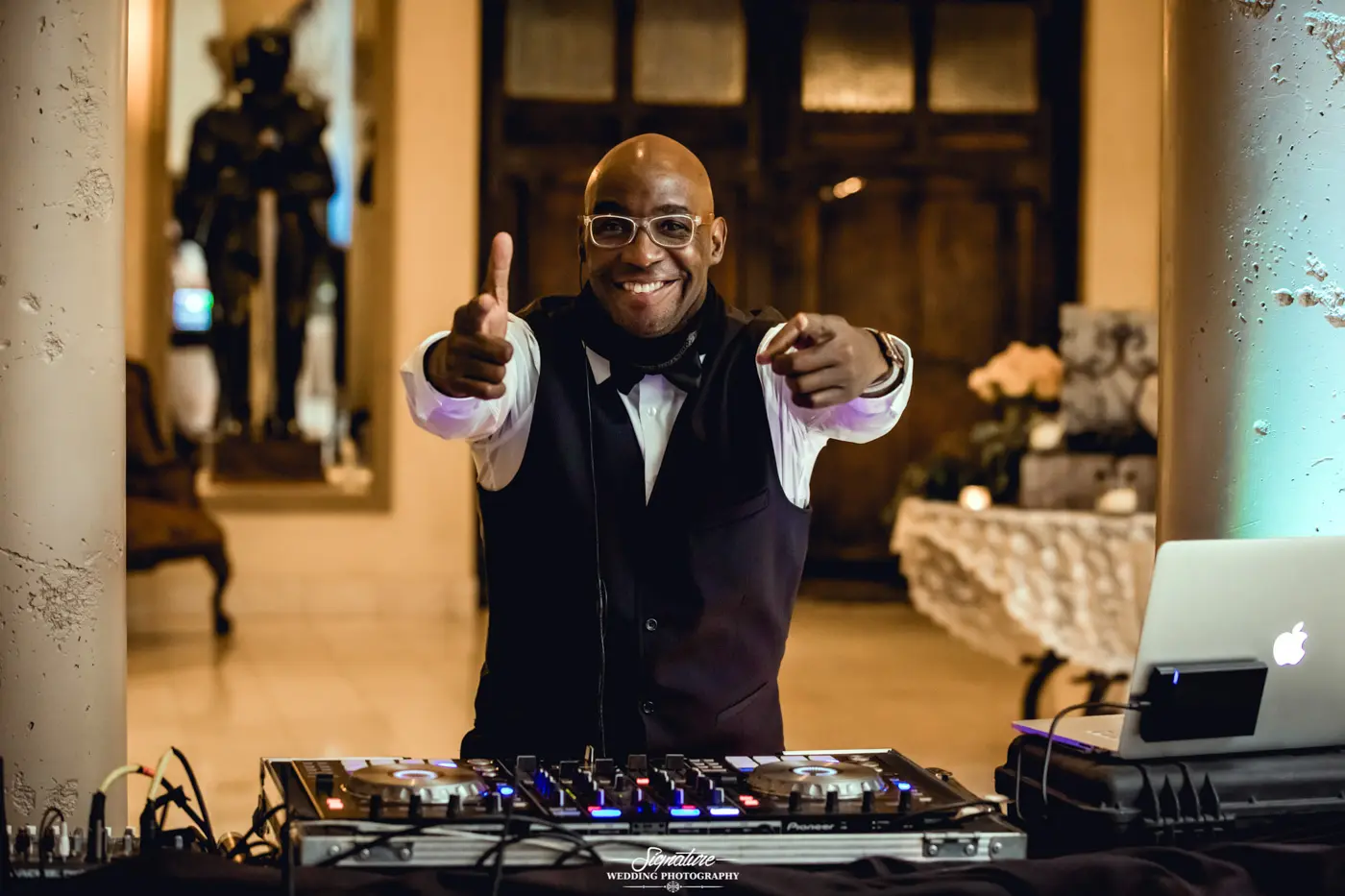 DJ smiling and pointing to camera