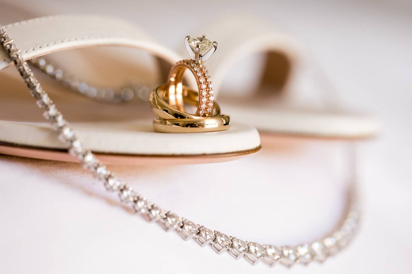 Close up shot of wedding rings, shoes, and jewelry