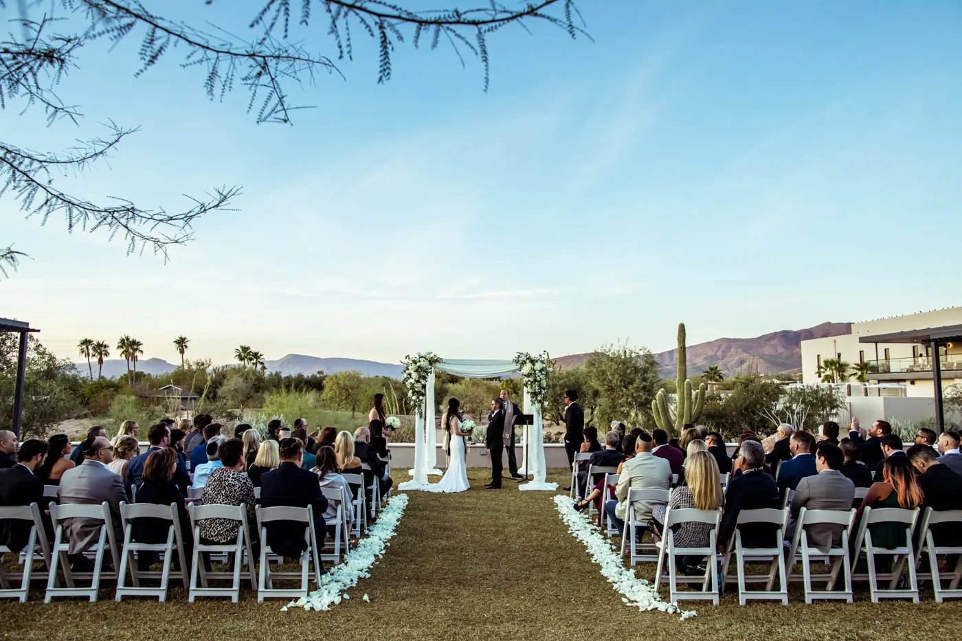 Bride and groom down aisle at archway during ceremony