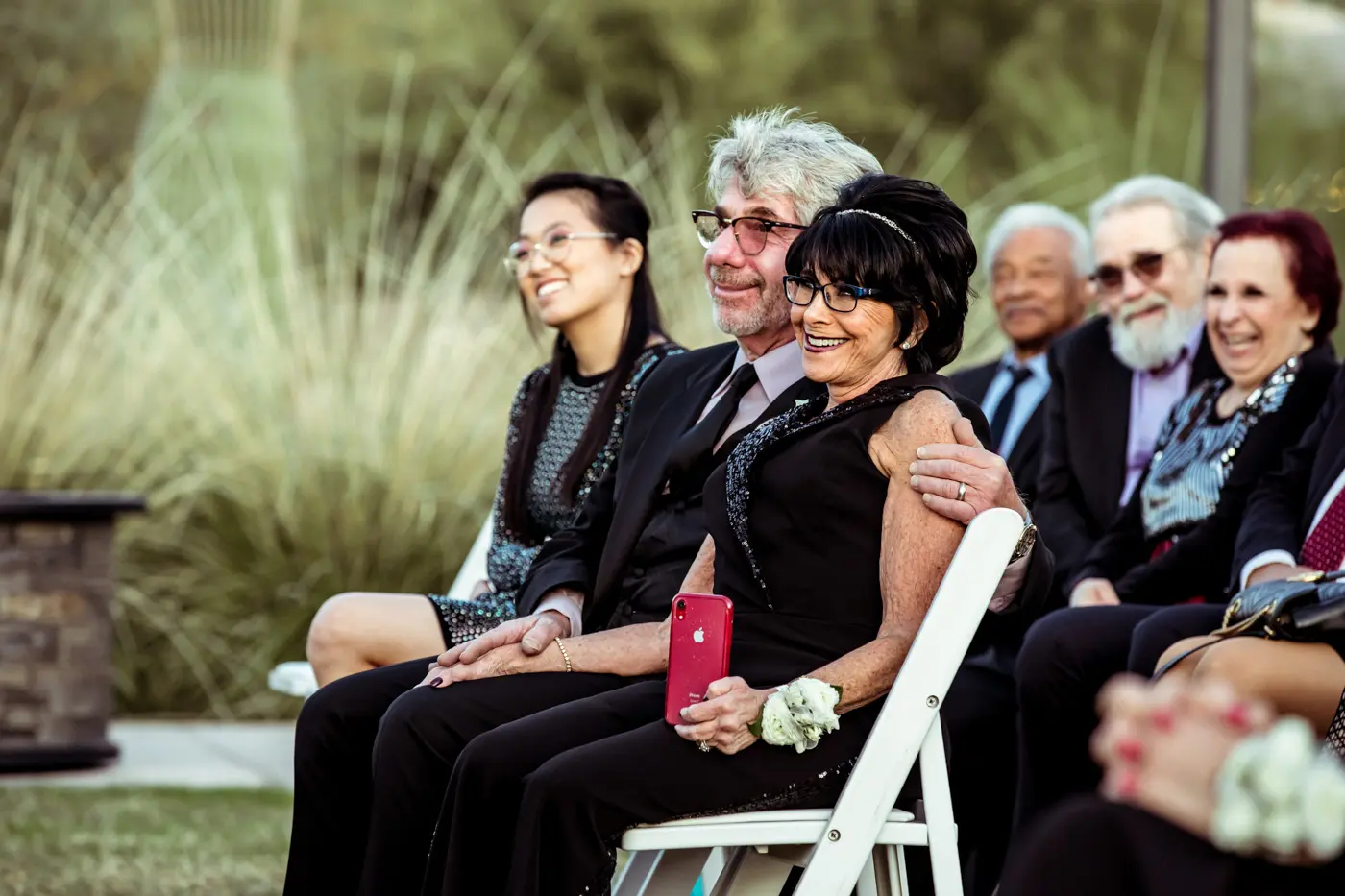 Wedding guests smiling during ceremony candid