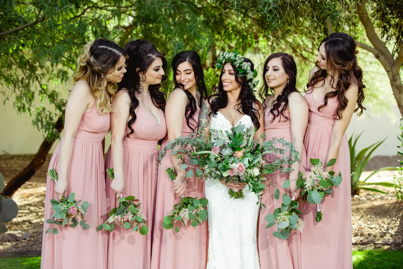 Bride and bridesmaids smiling at each other