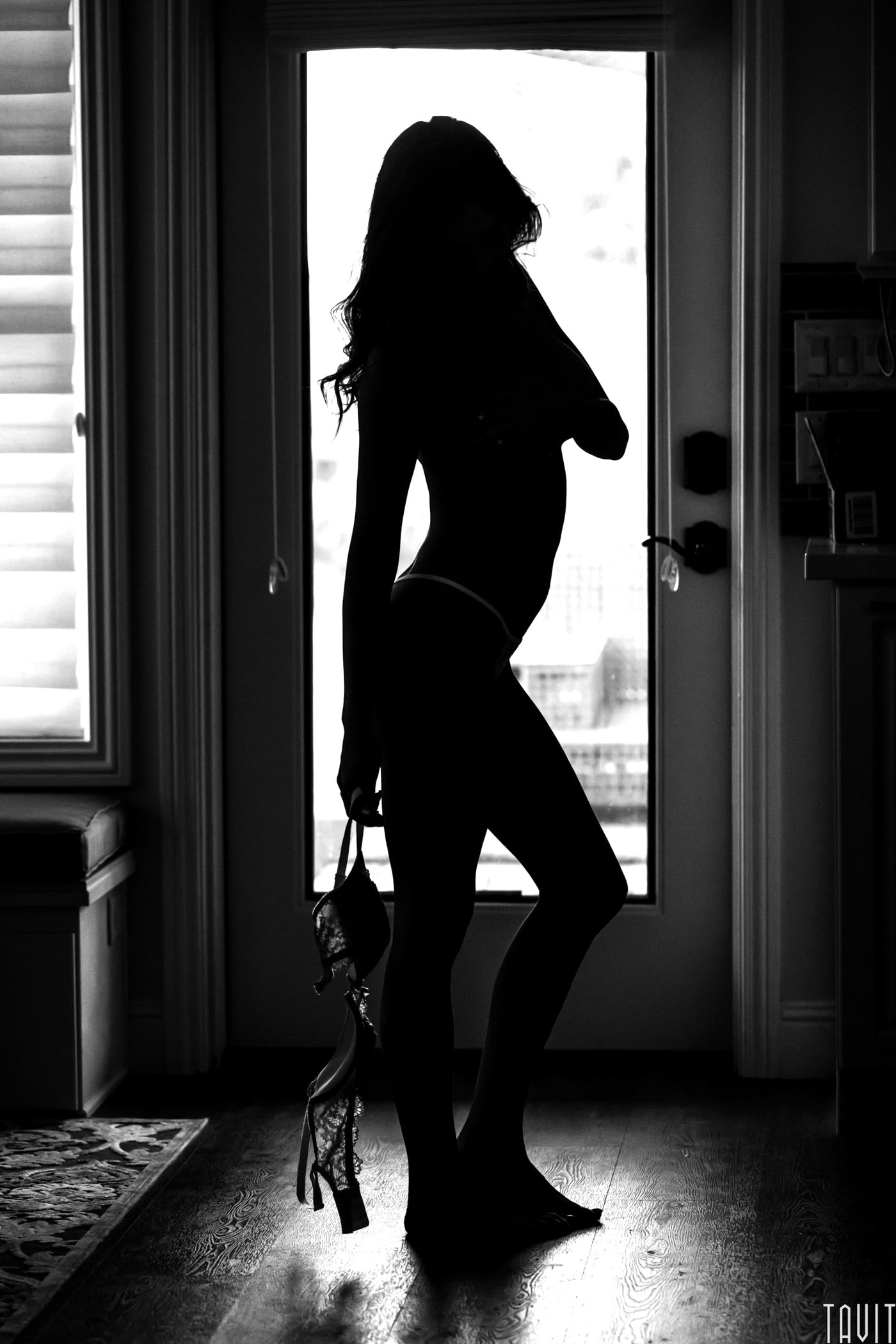 Model holding bra boudoir silhouette