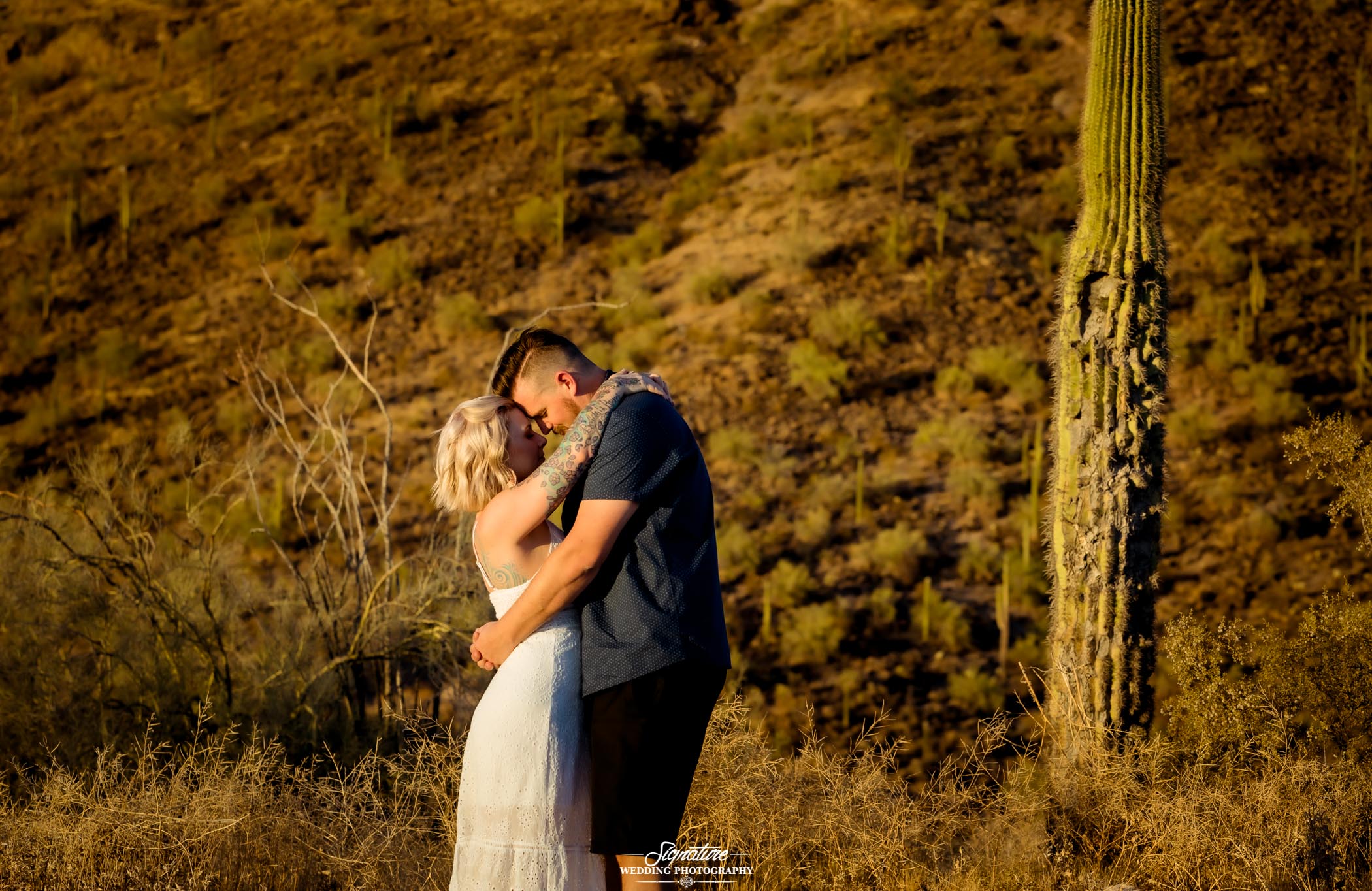 Couple in each other's arms in desert