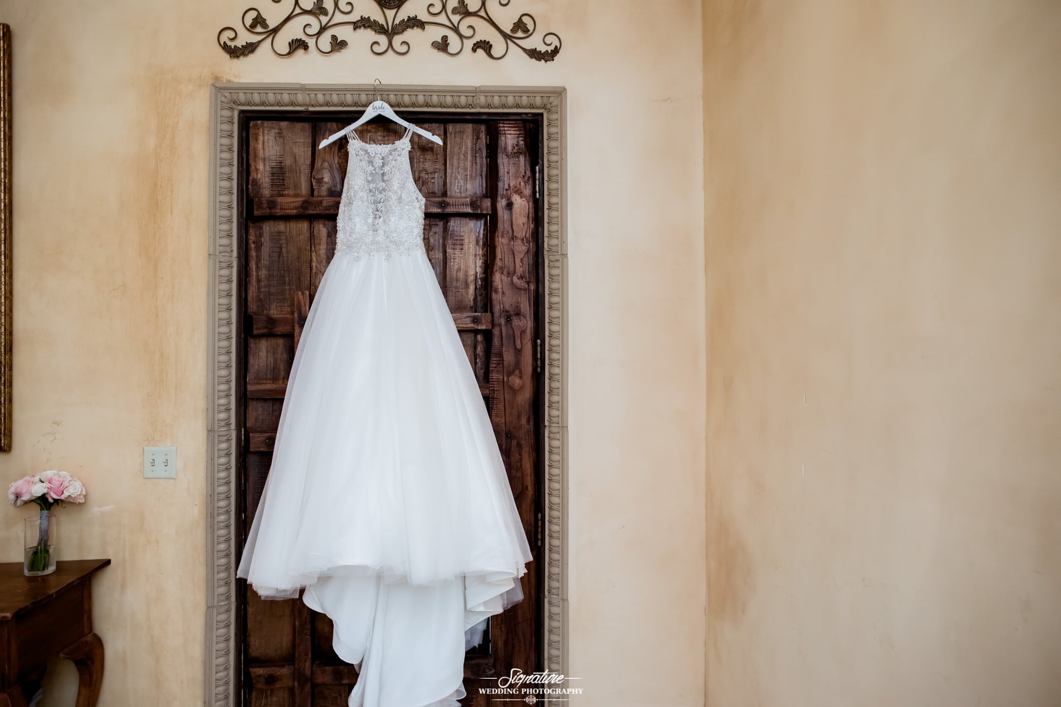 Wedding dress hanging above door