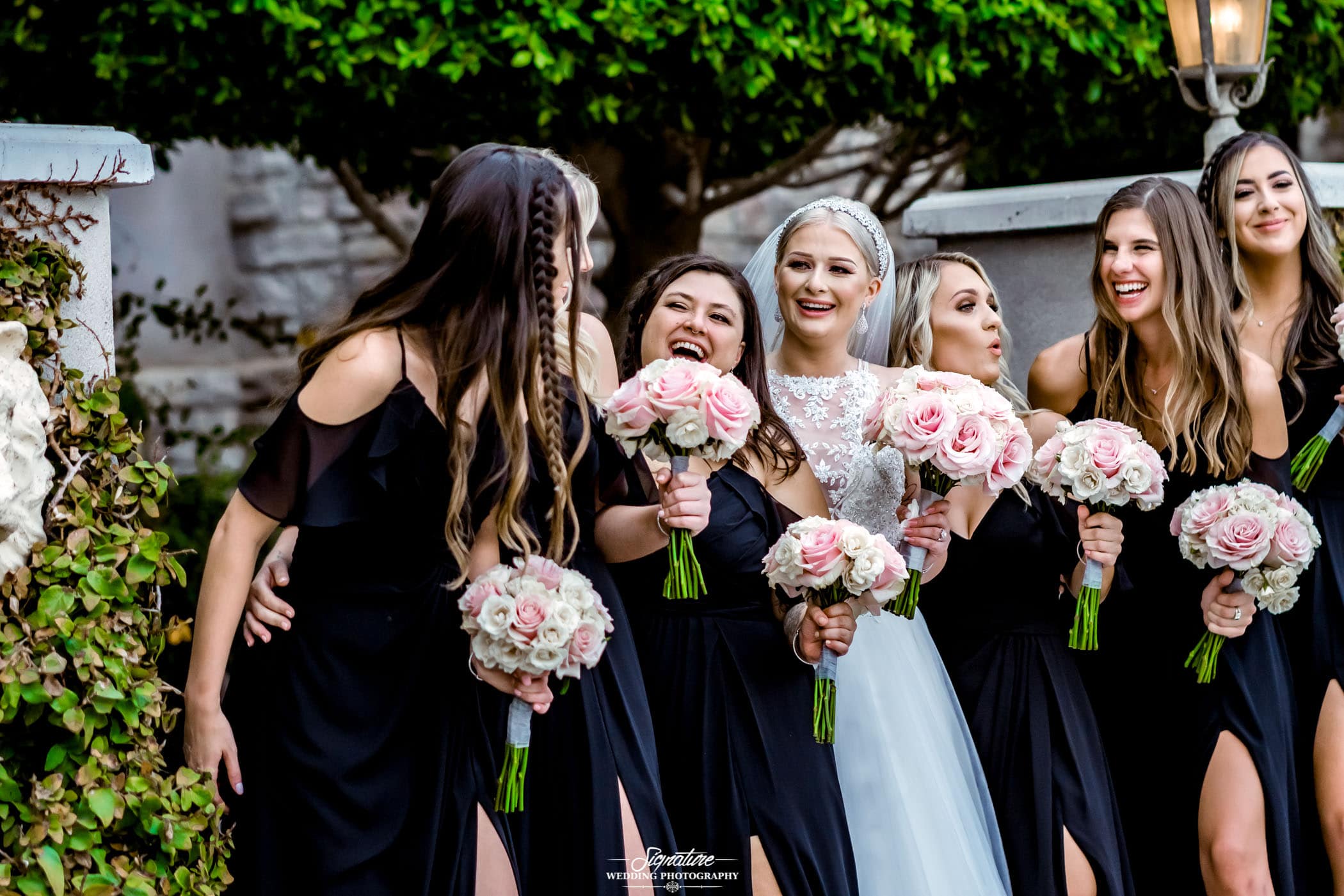 Bride and bridesmaids smiling at each other
