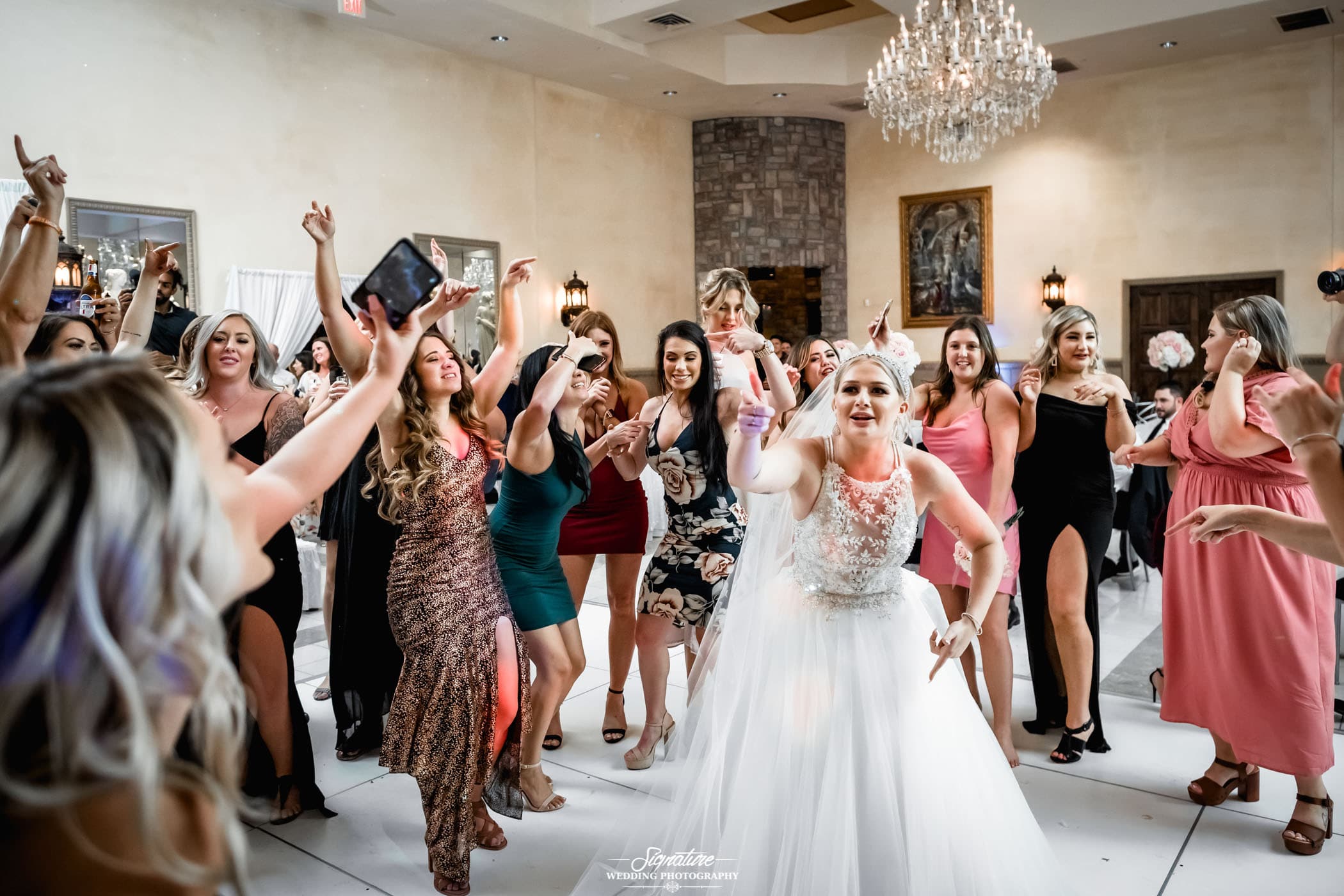 Bride dancing with wedding guests at reception